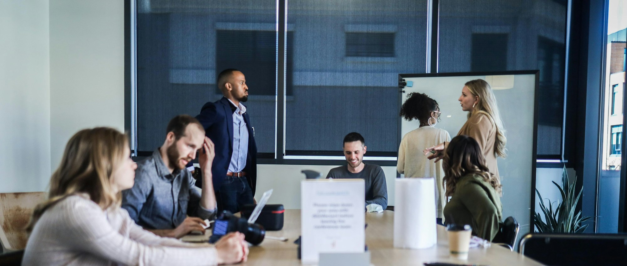 Multidisciplinary team meeting around a conference table in a bright office
